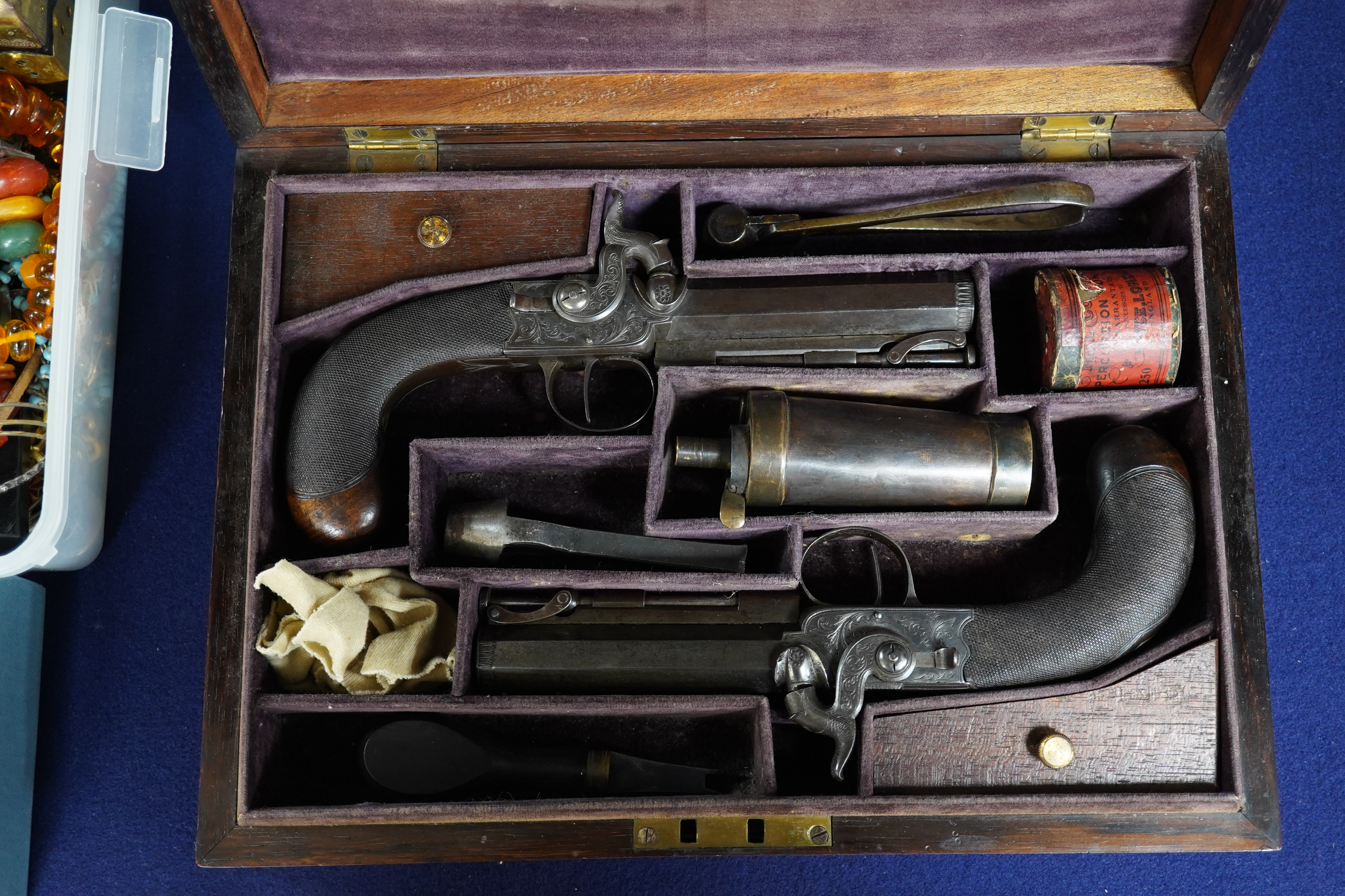 A pair of rosewood cased Blake & Co. London percussion cap travelling pistols, with octagonal barrels, engraved Blake & Co. London, Birmingham proof marks, side hammers, sliding safety bolts, swivel ramrods, foliate engr